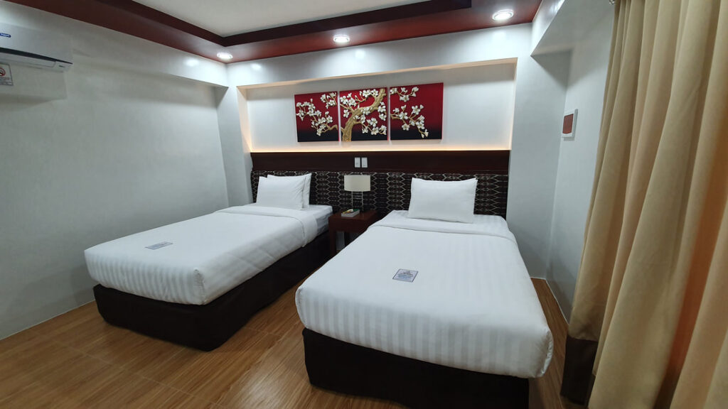 Two twin beds of the superior room in Dolores Lake Resort in Lake Sebu, South Cotabato