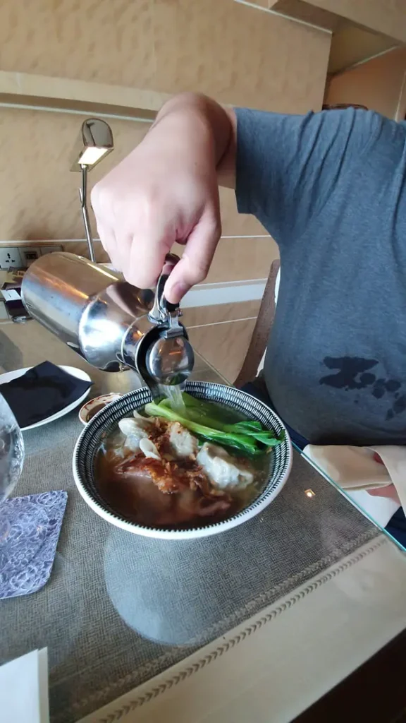 Pouring in the soup for the noodles in Shangrila at the Fort