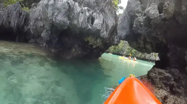 Kayaking in the small lagoon in El Nido showing the small entrance between limestones